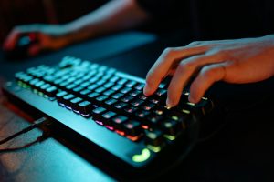 Person typing on black mechanical keyboard