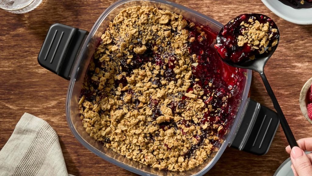 cherry cobber being spooned out of glass air fryer